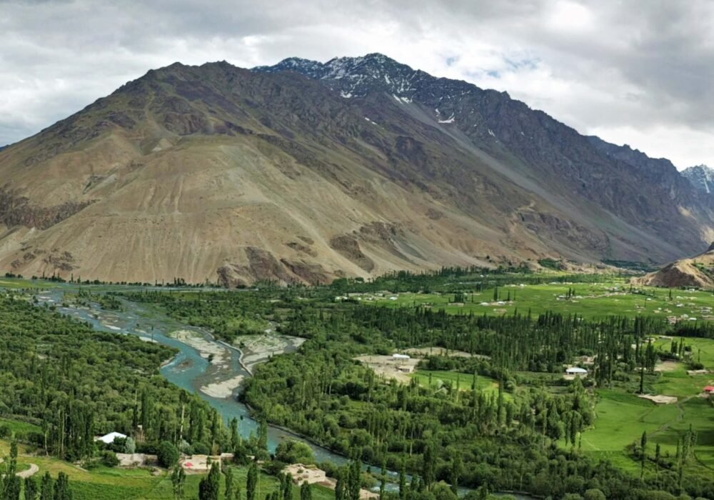 Trekkers exploring Hushe Valley surrounded by glaciers and Karakoram peaks in Gilgit Baltistan