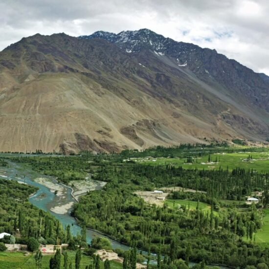Trekkers exploring Hushe Valley surrounded by glaciers and Karakoram peaks in Gilgit Baltistan