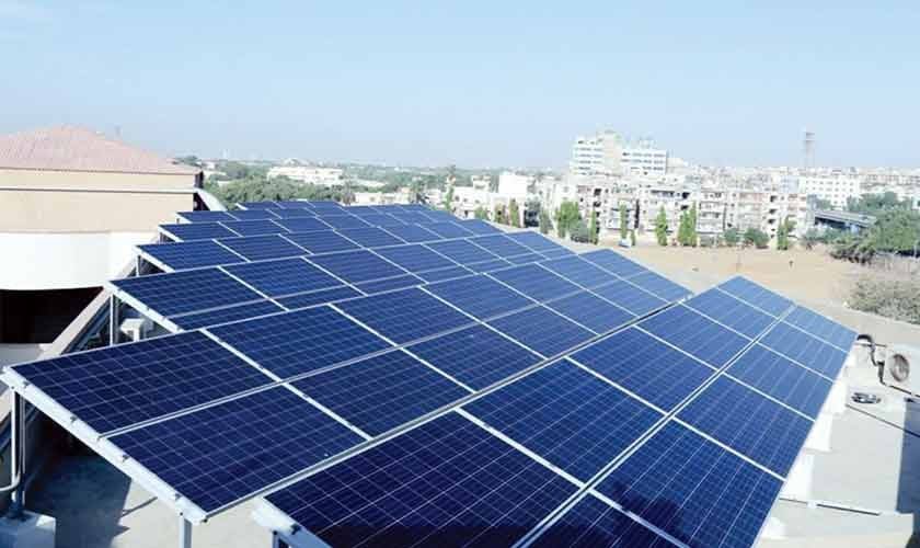 Solar installation team setting up commercial system under pakistan solar net metering policy